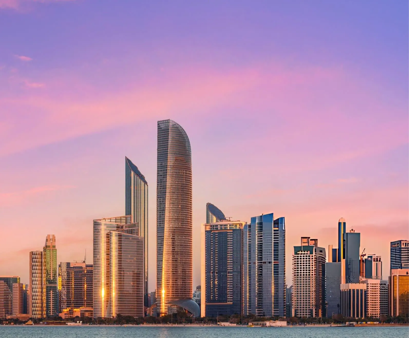 Modern skyline at dusk reflecting in the water